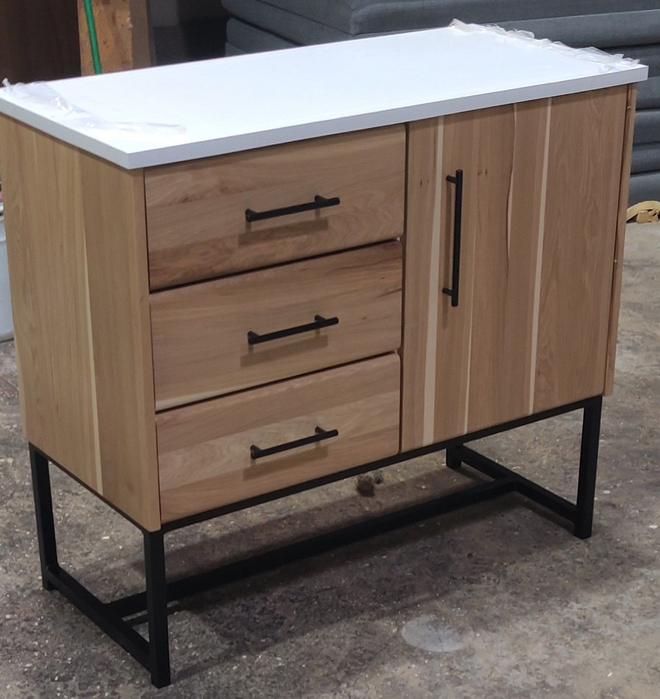 Wood credenza with three drawers and cabinet, stone top, black steel frame base