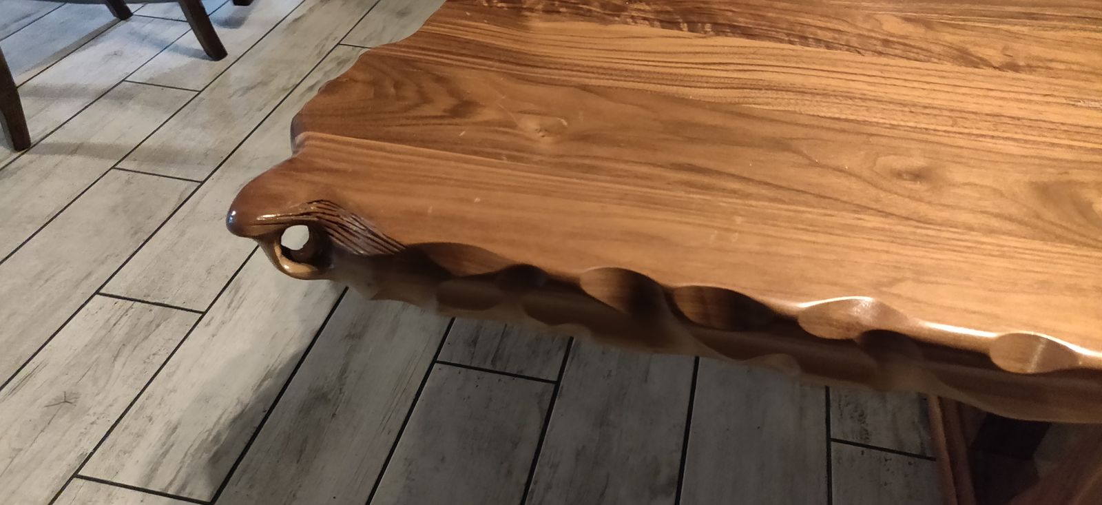 Scalloped hand-carved edge detail on a custom solid-wood tabletop